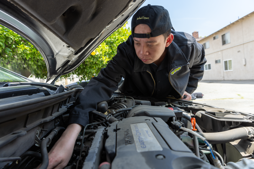 Andy Ly Tinker Expert working on his car