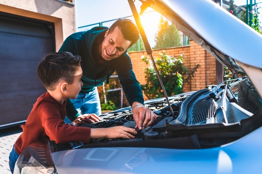 A father and son fixing their car
