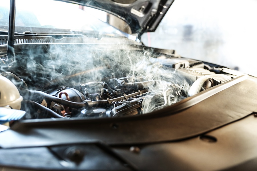 A closeup of an overheating engine